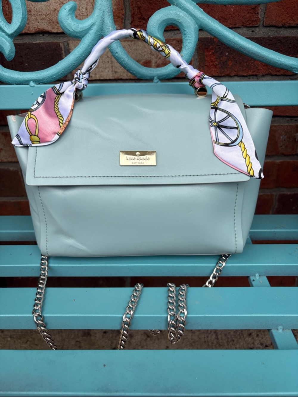 Kate Spade slate blue bag with Scarf-Wrapped Handle and silver chain crossbody.